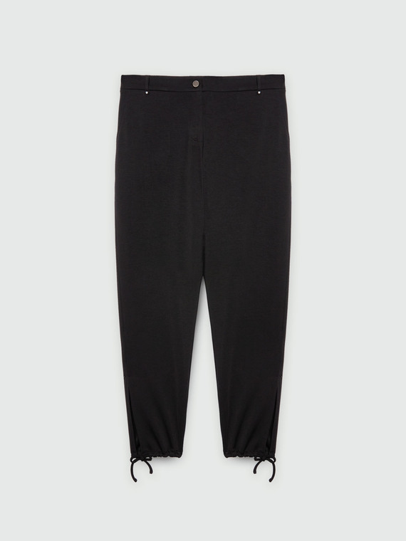 Trousers with laces at the bottom